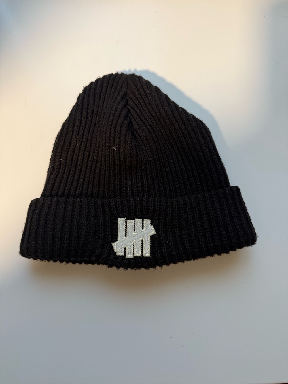 Undefeated Black Ribbed Beanie with White Tally Logo